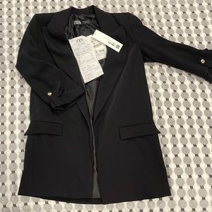 Black blazer with small shoulder pads.